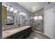 Bathroom featuring double sinks, granite countertops, and a glass shower at 13593 N 91St Way, Scottsdale, AZ 85260