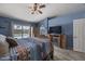 Bright bedroom with a ceiling fan, fireplace, and sliding glass doors leading to a pool at 13593 N 91St Way, Scottsdale, AZ 85260