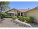 Charming front yard with desert landscaping, stone pathway, and tan exterior at 13593 N 91St Way, Scottsdale, AZ 85260
