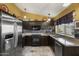 Well-lit kitchen features stainless steel appliances, granite countertops, and tiled backsplash at 13593 N 91St Way, Scottsdale, AZ 85260