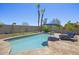 Relaxing pool area with lounge chairs, swaying palm trees, desert landscaping, and a clear blue in-ground pool for summer fun at 13593 N 91St Way, Scottsdale, AZ 85260