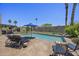 Backyard pool featuring a lounging area, an in-ground pool, desert landscaping, and mature trees with a privacy wall at 13593 N 91St Way, Scottsdale, AZ 85260