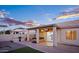 Backyard oasis with a hot tub, built-in grill, and easy-care landscaping, perfect for outdoor entertaining and leisure at 1398 W Windhaven Ave, Gilbert, AZ 85233