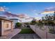 This backyard has a covered patio that is partially shaded and privacy fencing, perfect for relaxing and recreation at 1398 W Windhaven Ave, Gilbert, AZ 85233