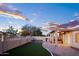 Backyard with covered patio, low-maintenance landscaping, and privacy fencing, creating an inviting space for outdoor enjoyment at 1398 W Windhaven Ave, Gilbert, AZ 85233