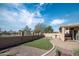 Relaxing backyard featuring artificial grass, a paved patio, an outdoor kitchen, and covered spa at 1398 W Windhaven Ave, Gilbert, AZ 85233