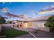 Backyard featuring a covered patio, outdoor kitchen area, and desert-friendly landscaping, for relaxing and entertaining at 1398 W Windhaven Ave, Gilbert, AZ 85233