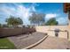 An inviting backyard with an outdoor kitchen, artificial turf, and paver patio at 1398 W Windhaven Ave, Gilbert, AZ 85233