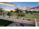 This backyard features a partial view of a greenbelt, an iron fence, and mature landscaping at 1398 W Windhaven Ave, Gilbert, AZ 85233