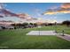 Community basketball court offering recreational opportunities for residents, featuring a beautiful sunset view at 1398 W Windhaven Ave, Gilbert, AZ 85233