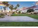 Outdoor basketball court and play structure surrounded by towering palm trees in a Gathering-friendly community at 1398 W Windhaven Ave, Gilbert, AZ 85233
