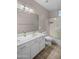 This bathroom features a double sink vanity, large mirror, and bathtub with sliding glass doors at 1398 W Windhaven Ave, Gilbert, AZ 85233