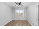 Bright bedroom with wood-style flooring, neutral walls, and a window with shutter style blinds at 1398 W Windhaven Ave, Gilbert, AZ 85233