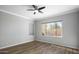 Cozy bedroom with wood-style flooring, a large window, and neutral walls for versatile décor at 1398 W Windhaven Ave, Gilbert, AZ 85233