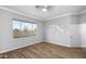 Bedroom boasts wood-style flooring, neutral walls, and a large window for natural light at 1398 W Windhaven Ave, Gilbert, AZ 85233