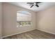 Bedroom with hardwood floors, natural light from the window, and neutral paint creating a calm atmosphere at 1398 W Windhaven Ave, Gilbert, AZ 85233