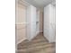 Walk-in closet featuring custom shelving and storage solutions, with hardwood floors and neutral paint at 1398 W Windhaven Ave, Gilbert, AZ 85233