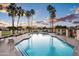 Enjoy the community pool, complete with tall palm trees, plenty of seating and shade, for poolside lounging at 1398 W Windhaven Ave, Gilbert, AZ 85233