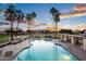 Community pool area with palm trees, lounge chairs, and seating providing a resort-like atmosphere at 1398 W Windhaven Ave, Gilbert, AZ 85233