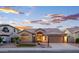 Charming single-story home with a tile roof and low-maintenance desert landscaping against a beautiful sunset sky at 1398 W Windhaven Ave, Gilbert, AZ 85233