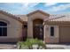 Front entrance featuring a decorative door, tile roof, and desert landscaping at 1398 W Windhaven Ave, Gilbert, AZ 85233