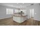 Well-lit kitchen featuring white cabinets, a center island, and stainless steel appliances at 1398 W Windhaven Ave, Gilbert, AZ 85233