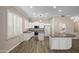 Bright kitchen featuring white cabinets, granite counters, and stainless steel appliances at 1398 W Windhaven Ave, Gilbert, AZ 85233