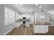 Well-lit kitchen featuring white cabinets, a center island, and stainless steel appliances at 1398 W Windhaven Ave, Gilbert, AZ 85233