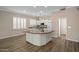 Bright open kitchen featuring an island, white cabinetry, and stainless appliances at 1398 W Windhaven Ave, Gilbert, AZ 85233