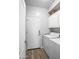 Bright laundry room with washer, dryer, overhead cabinets, and a door to the outside at 1398 W Windhaven Ave, Gilbert, AZ 85233
