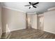 Neutral living room featuring hardwood floors, a ceiling fan, and convenient access to other rooms at 1398 W Windhaven Ave, Gilbert, AZ 85233