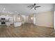 Open-concept living room features hardwood floors, modern ceiling fan, and ample natural light at 1398 W Windhaven Ave, Gilbert, AZ 85233