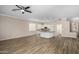 Spacious living area featuring hardwood floors, neutral paint, lots of natural light, and a modern ceiling fan at 1398 W Windhaven Ave, Gilbert, AZ 85233