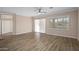 Open-concept living room with wood flooring, neutral tones, and bright windows at 1398 W Windhaven Ave, Gilbert, AZ 85233
