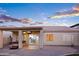 Covered patio with hot tub and view into open floor plan through sliding glass doors provides indoor-outdoor living at 1398 W Windhaven Ave, Gilbert, AZ 85233
