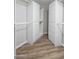 This walk-in closet features wooden floors and white closet organizers for optimal storage solutions at 1398 W Windhaven Ave, Gilbert, AZ 85233