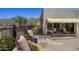 Back patio with a stone surface, seating, and desert mountain views at 14007 E Lupine Ave, Scottsdale, AZ 85259