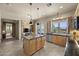 Spacious kitchen with granite island, ample cabinetry, and access to an outdoor dining area at 14007 E Lupine Ave, Scottsdale, AZ 85259