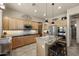 Modern kitchen featuring custom cabinets, stainless appliances, and a granite-topped island with seating at 14007 E Lupine Ave, Scottsdale, AZ 85259