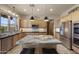 Bright kitchen featuring stainless steel appliances, granite counters, and a functional island with bar seating at 14007 E Lupine Ave, Scottsdale, AZ 85259