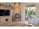 Living room with large fireplace and access to the pool area at 14007 E Lupine Ave, Scottsdale, AZ 85259