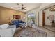 Comfortable living room with large windows offering backyard views, ceiling fan, and cozy seating at 14007 E Lupine Ave, Scottsdale, AZ 85259