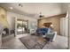 Open living room with fireplace, ceiling fan, tile floor, and sliding doors to backyard at 14007 E Lupine Ave, Scottsdale, AZ 85259