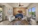 Living room featuring comfortable seating, a ceiling fan, and sliding doors to the yard at 14007 E Lupine Ave, Scottsdale, AZ 85259