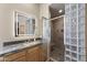 Bathroom featuring a vanity with a framed light-up mirror and glass block framed shower at 14007 E Lupine Ave, Scottsdale, AZ 85259