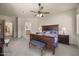 Spacious main bedroom with a wooden bed frame, ceiling fan, and access to an ensuite bathroom at 14007 E Lupine Ave, Scottsdale, AZ 85259