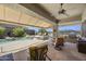 Covered outdoor patio with comfortable seating, BBQ, and a beautiful pool at 14007 E Lupine Ave, Scottsdale, AZ 85259