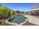 Sparkling backyard pool featuring a stone waterfall feature and desert landscape views at 14007 E Lupine Ave, Scottsdale, AZ 85259