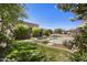 Beautiful backyard pool area with mature landscaping and a stone waterfall at 14007 E Lupine Ave, Scottsdale, AZ 85259