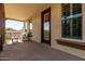 Inviting balcony with decorative columns, a black metal railing, and an outdoor seating area at 15456 W Corrine Dr, Surprise, AZ 85379